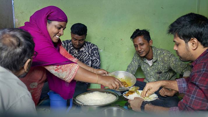 Lima serves food to customers of her catering business in Barishal, Bangladesh.