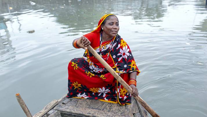 Mishty rows her own water taxi on the Kirthonkhola River in Bangladesh.