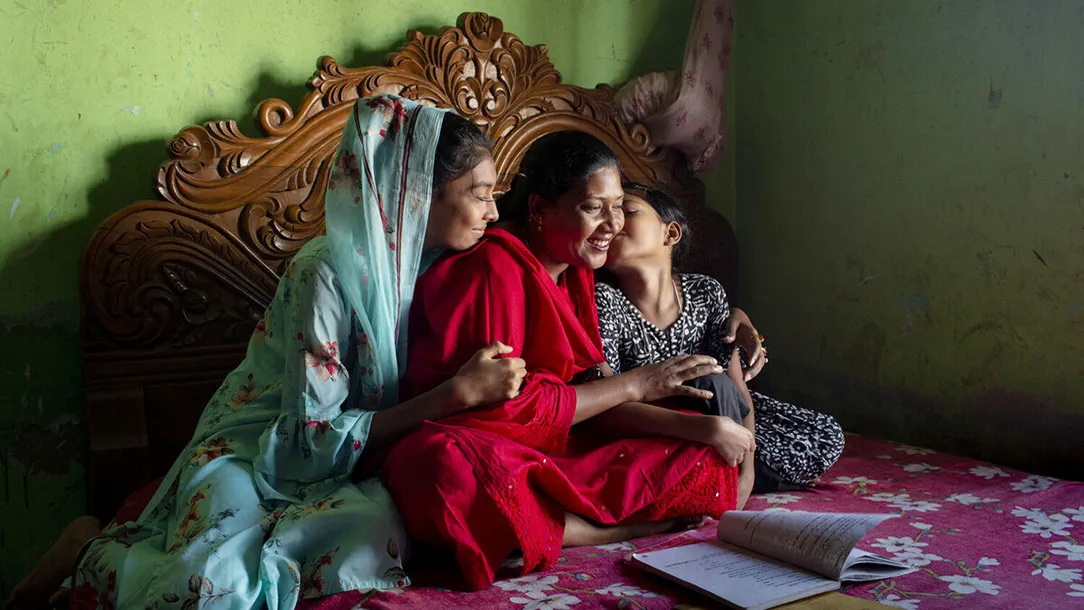 Mukul helps her daughters study at home in Barishal, Bangladesh.