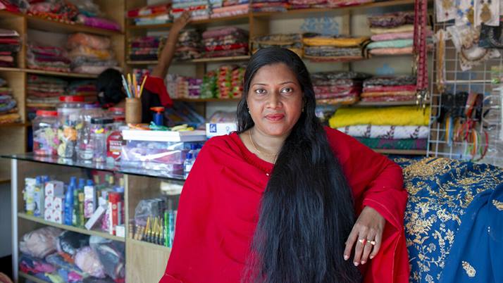 Mukul stands in her own clothing shop in Barishal, Bangladesh.