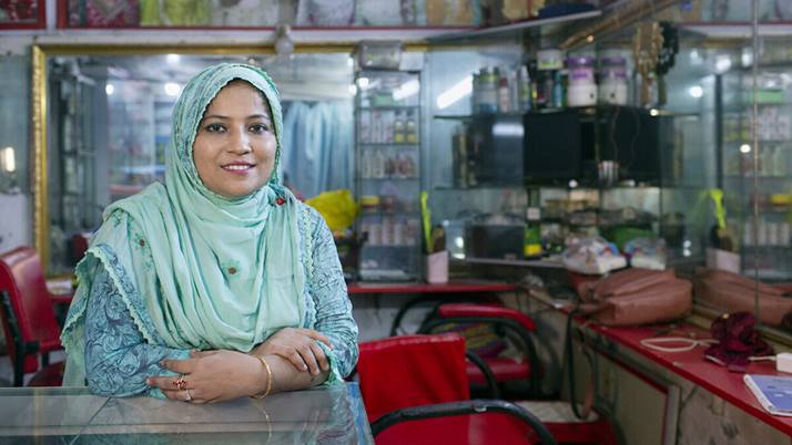 Taslima sits in her own beauticians in Barishal, Bangladesh.