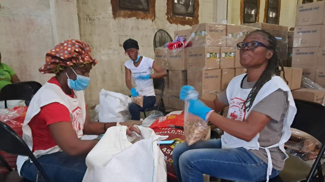 Volunteers from the Jamaican Red Cross prepare supplies for communities in a warehouse