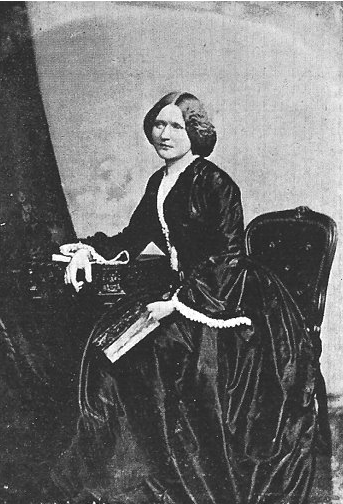 Black and white image of a lady sat in regal clothes