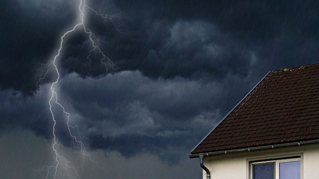 Lightning and storm clouds near a house