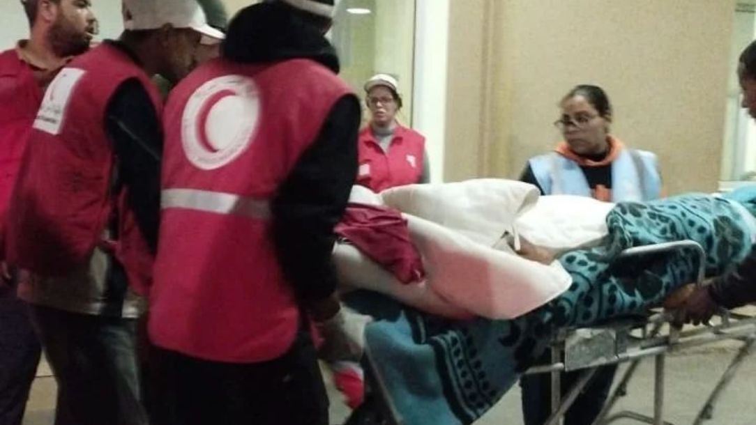 Morocco Red Crescent teams transport an injured person after the Morocco 2023 earthquake.