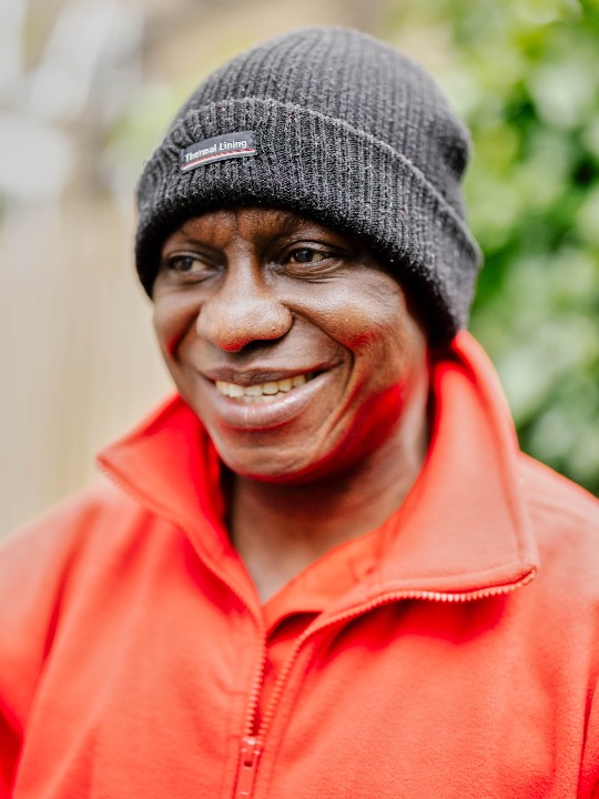 Volunteer David smiles in this portrait of him wearing his Red Cross uniform