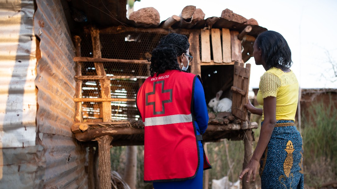 Evelyn talks to Jemimah by her chicken coop. PHOTO: Allan Gichcigi/British Red Cross
