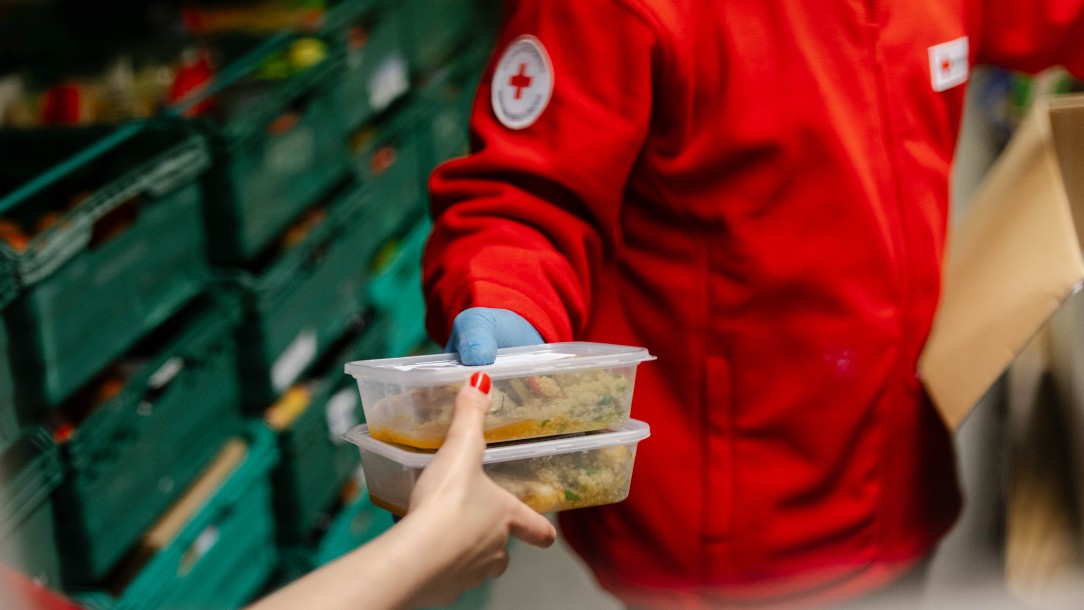 Volunteers at our centre in Hackney, east London, pass each other food parcels to be packed 