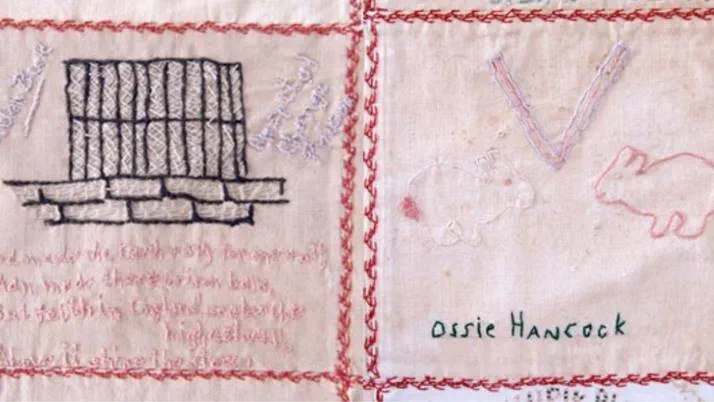 Quilt squares by Helen Beck and Ossie Hancock, whose square depicts a V, presumably for 'Victory' and two rabbits, which might have been a message for her family