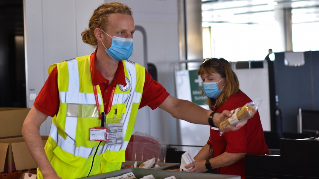 British Red Cross volunteer Henry distributing food at Heathrow Airport