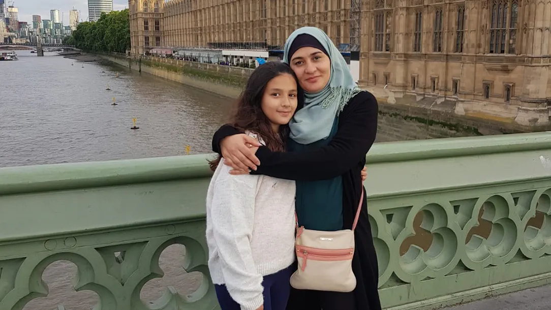 Mada and her daughter Hala stand together in central London. Mada and her family were reunited in the UK after fleeing Syria 