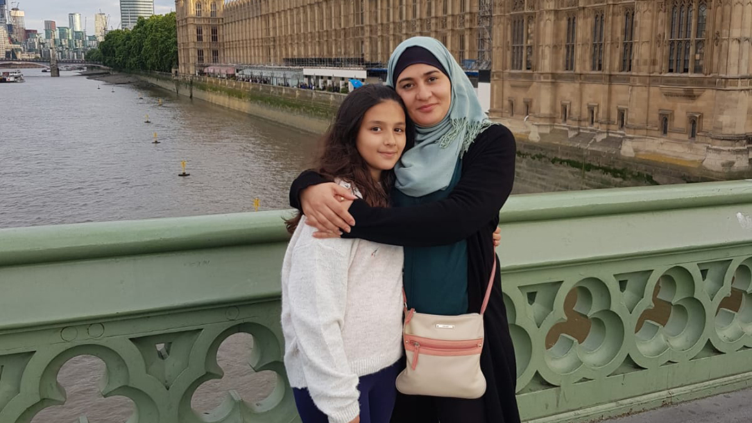 Mada and her daughter Hala stand together in central London. Mada and her family were reunited in the UK after fleeing Syria