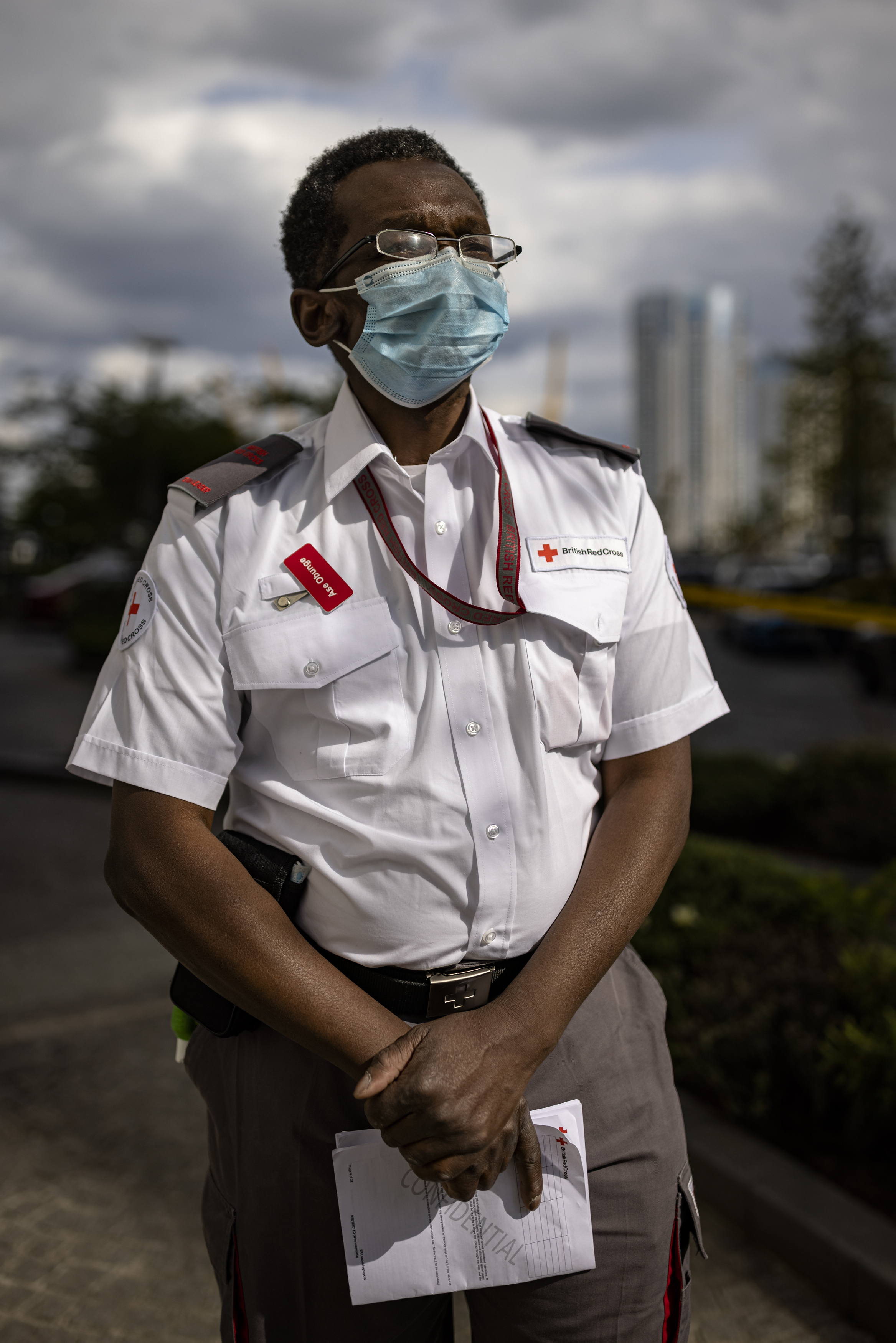 Volunteer and team leader Ase stands in his uniform at the scene of the fire in Poplar, East London