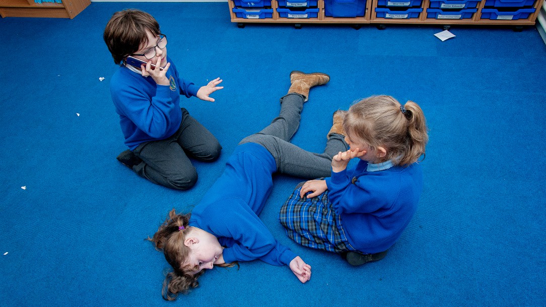 Stephen and other children from Christchurch Primary School practise first aid in school.