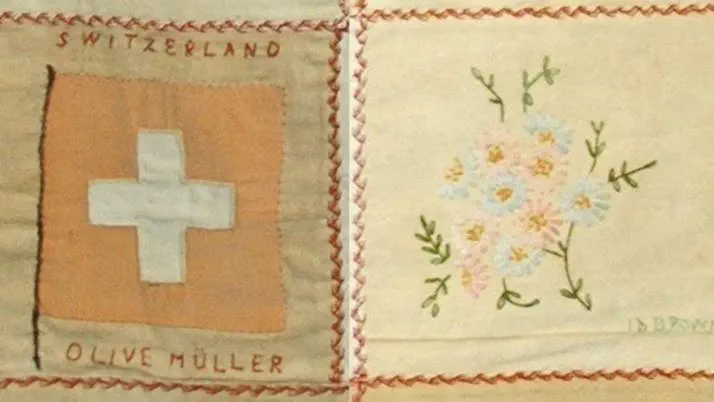 A quilt square depicting the Swiss flag and a quilt square depicting a bunch of flowers