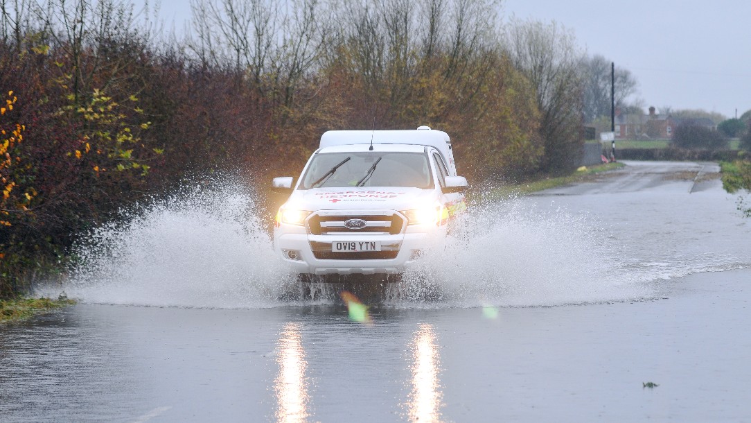 Emergency response volunteer Kenny drives through floodwater in a British Red Cross vehicle to reach the community of Fishlake, Doncaster.