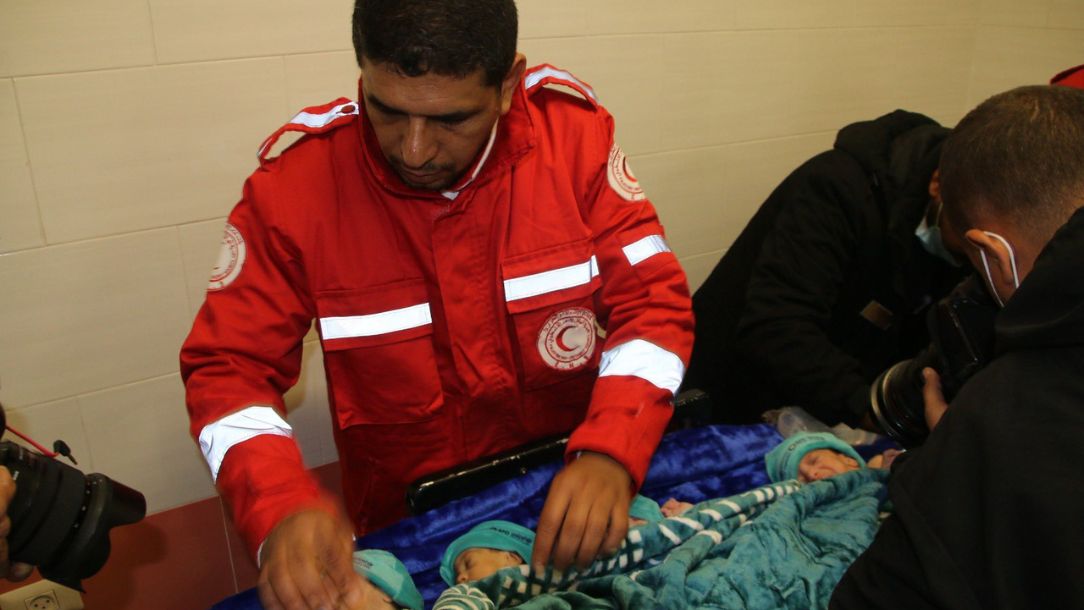 A Palestine Red Crescent worker helps move premature babies to safety in Gaza