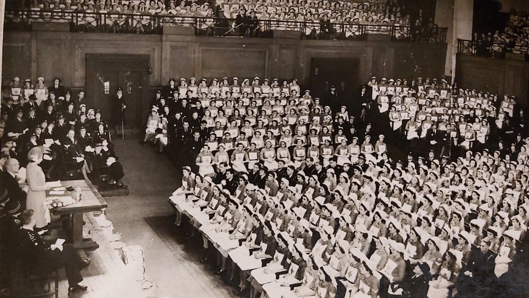 A black and white photo showing then Princess Elizabeth II giving a speech to young British Red Cross volunteers at Friends House.