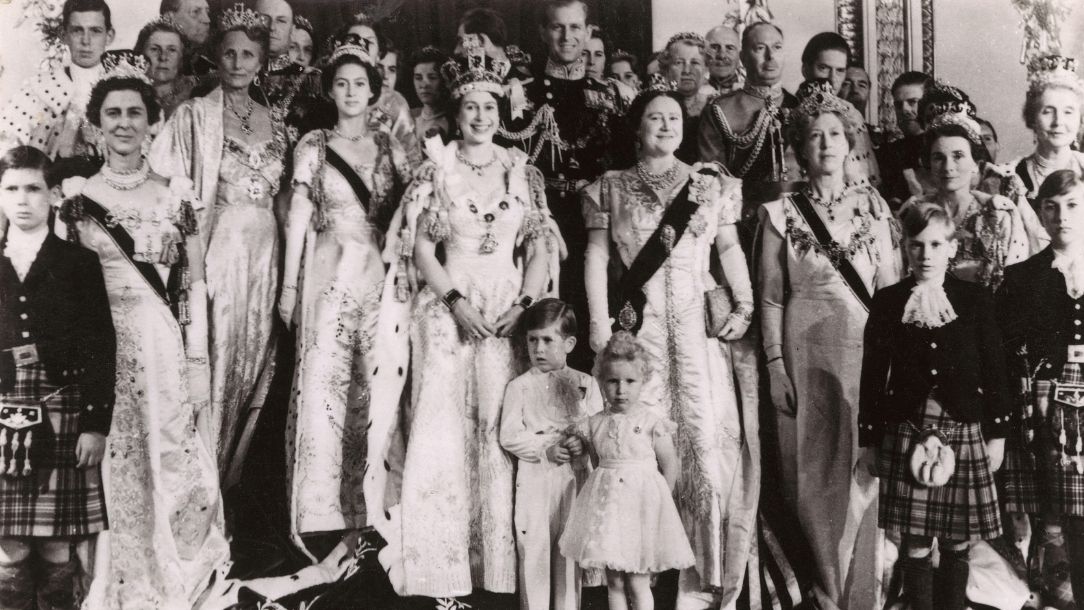 A black and white photograph showing a commemorative postcard from Queen Elizabeth II's coronation in 1952