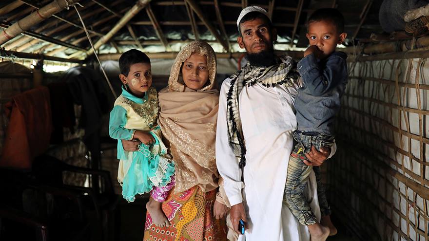 Couple pose for photo with their two young children