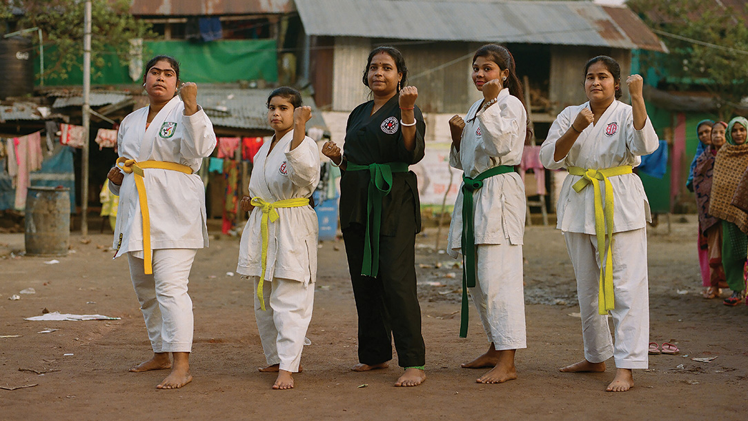 Group of women pose in their karate uniform