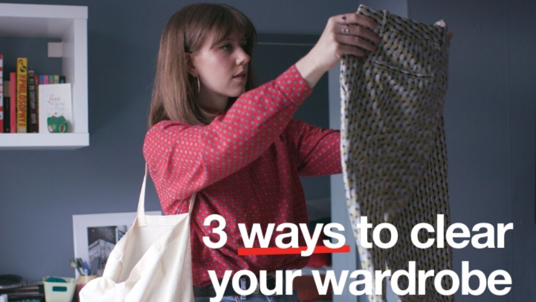 A woman sorts through clothes to donate to a British Red Cross charity shop.