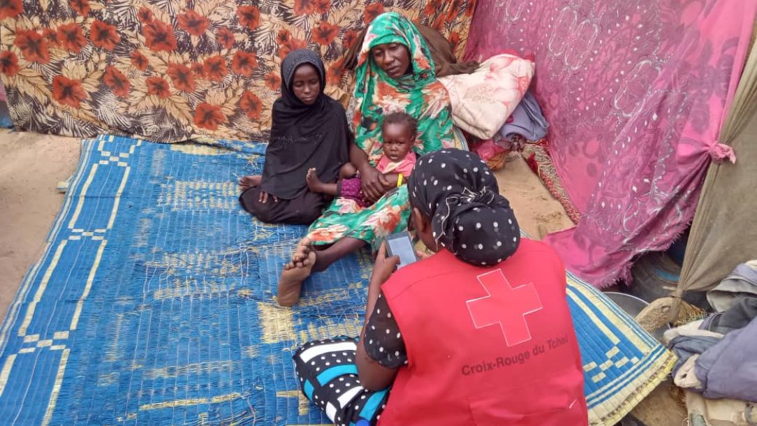 A mother and her two children who have fled conflict in Sudan and are seeking refuge in Chad.