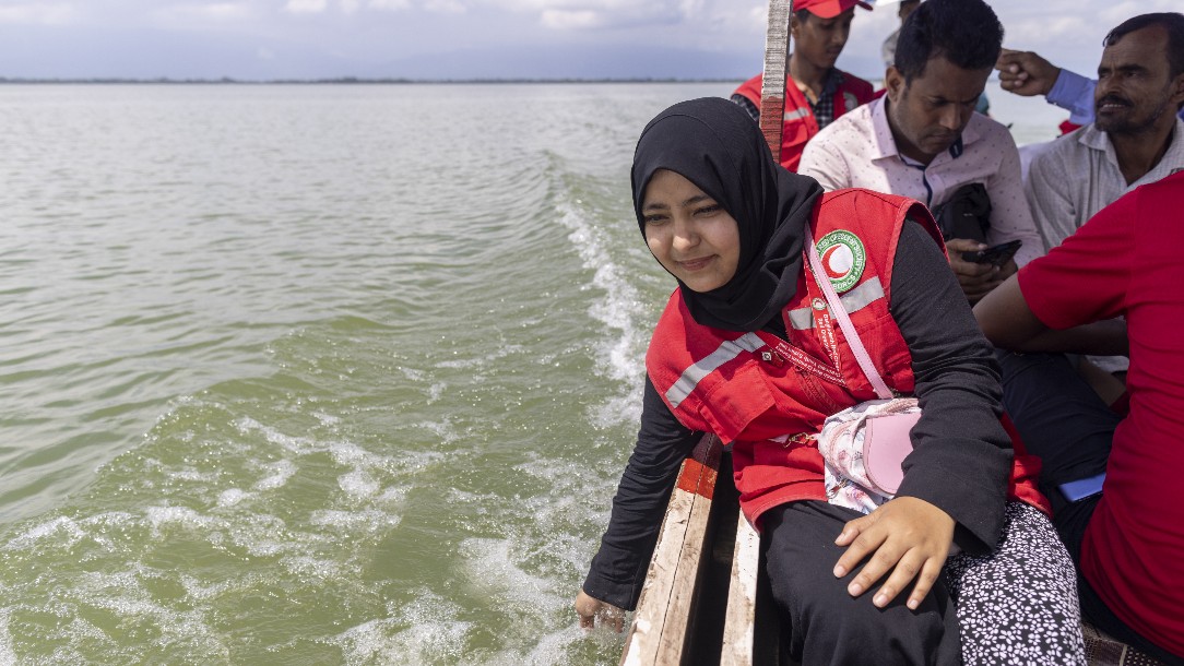 Bangladesh Red Crescent worker Amina takes ride on a boat to distribute food to flood-affected people in Compnyganj, Bangladesh