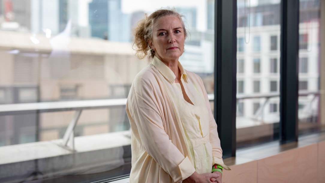 Carrie looks at the camera while stood in front of the windows at the ICRC offices in London