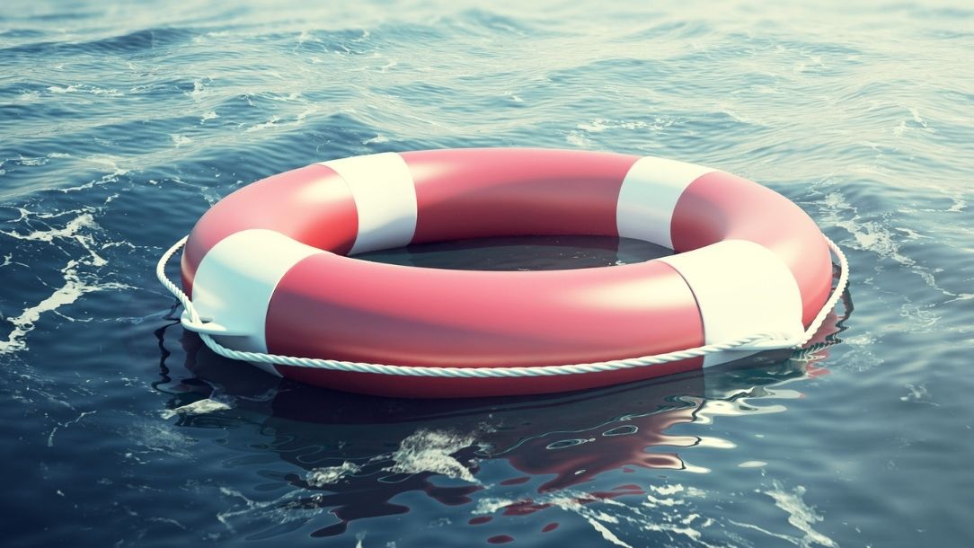 A red lifebuoy floating in open water from a British Red Cross blog about drowning in open water
