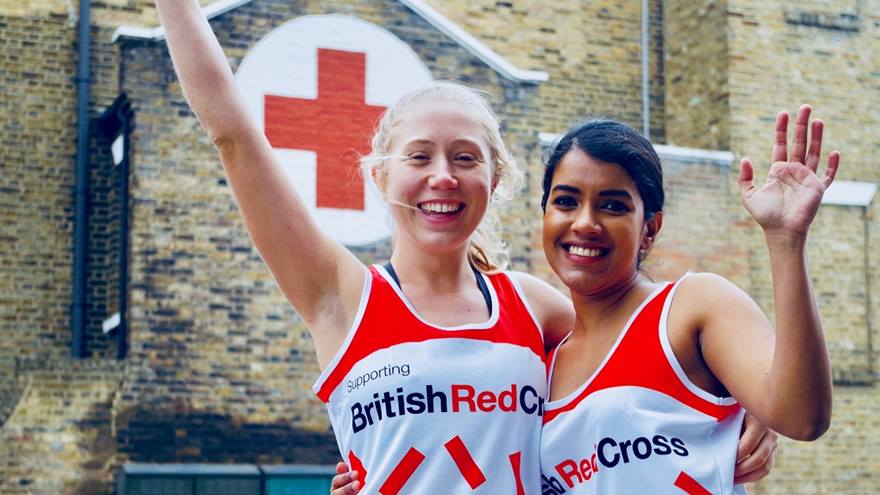 Two Red Cross runners cheering 