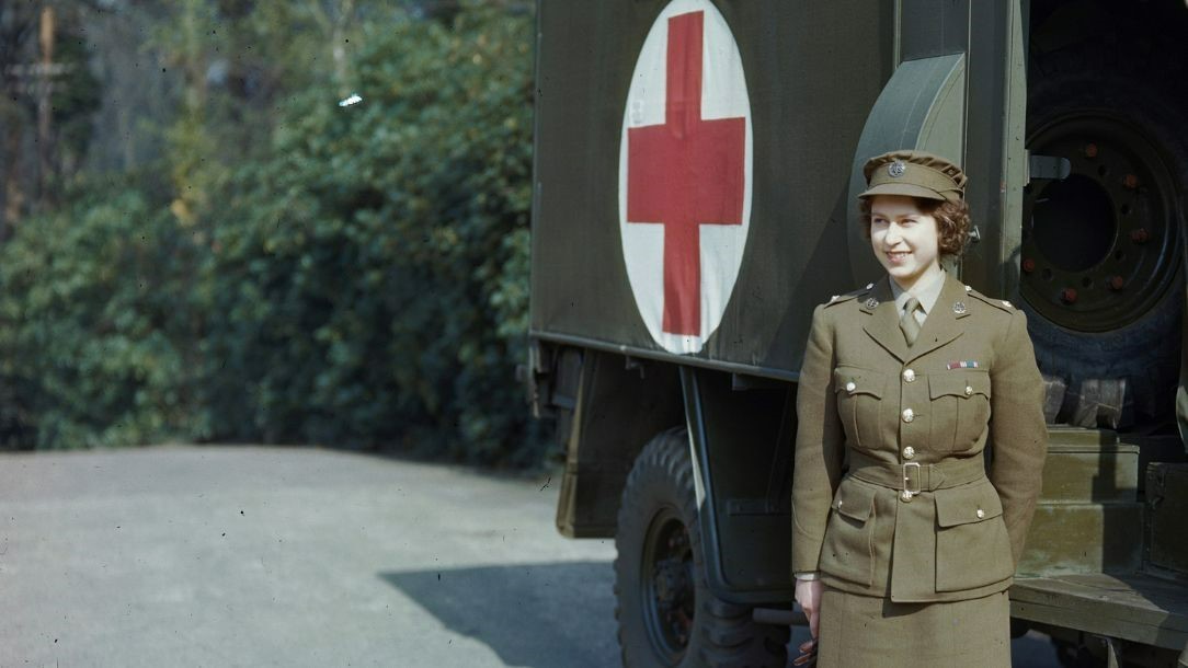 The Queen stands in front of a Red Cross emergency vehicle