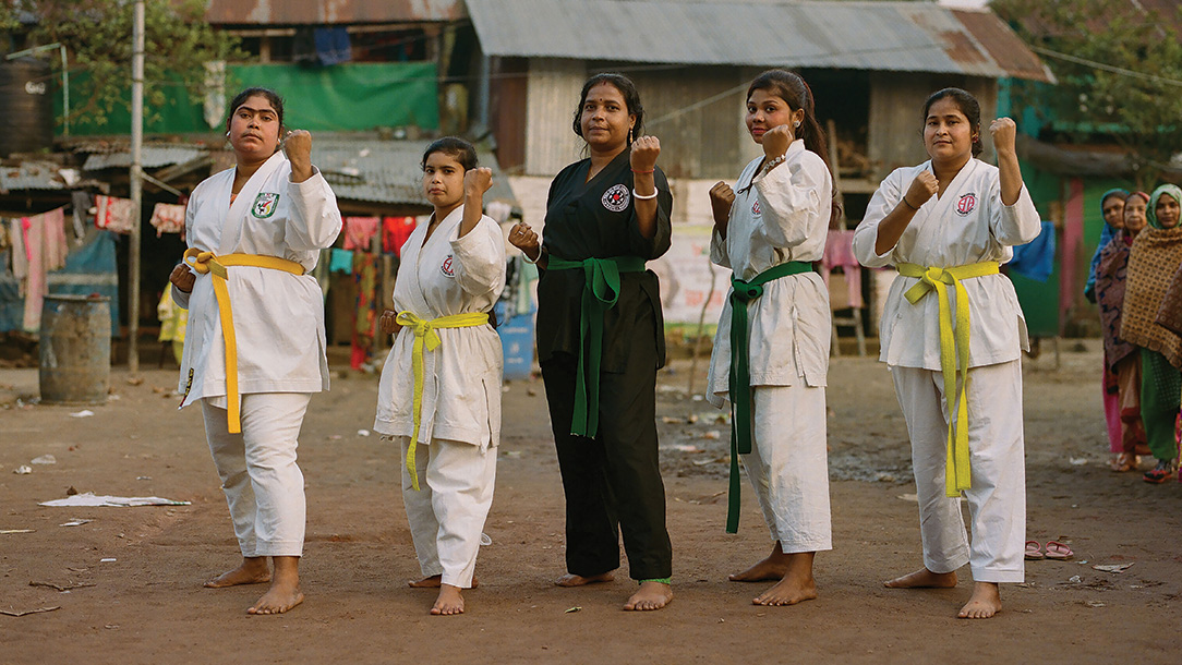 Group of women pose in their karate uniform