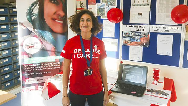 Tala wears her British Red Cross t shirt which reads 'Because I Care' while volunteering.