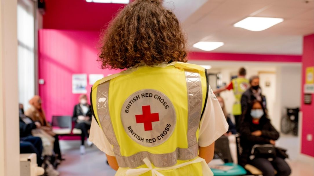 Tala, in her British Red Cross vest, volunteers at the vaccine clinic
