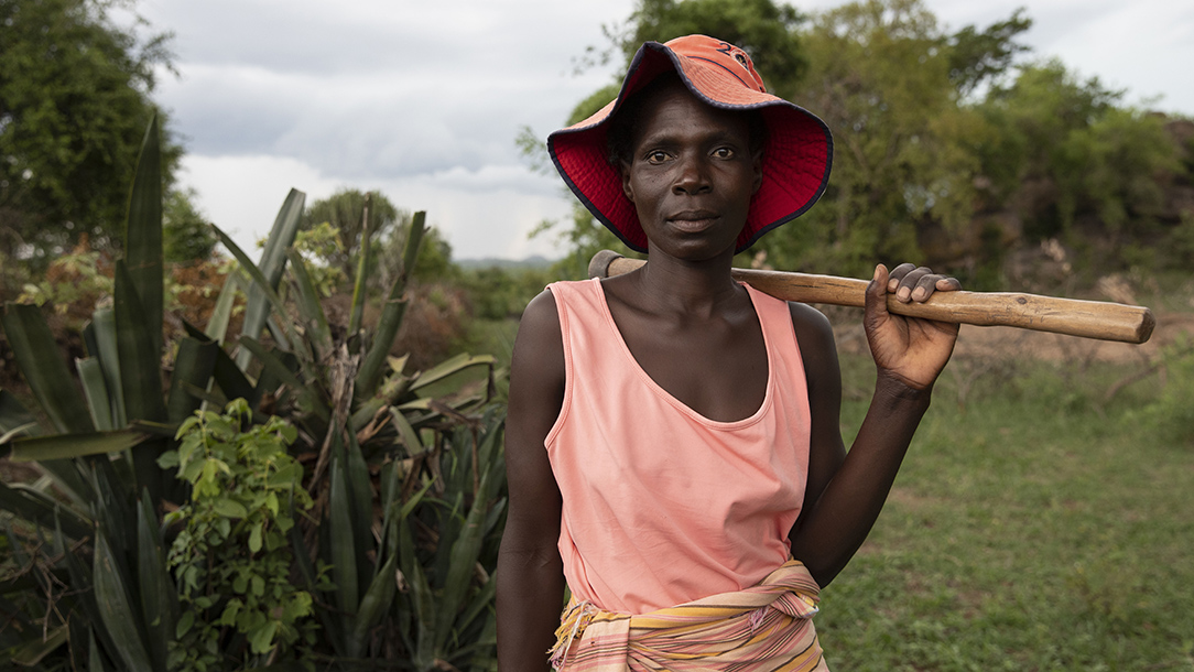 Tirisai Mubhoyi, a widow and mother of four, holds the tool she uses to look after the keyhole garden she built.