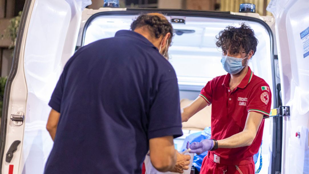 A member of the Italian Red Cross treats a man affected by extreme heat in Italy in 2023.